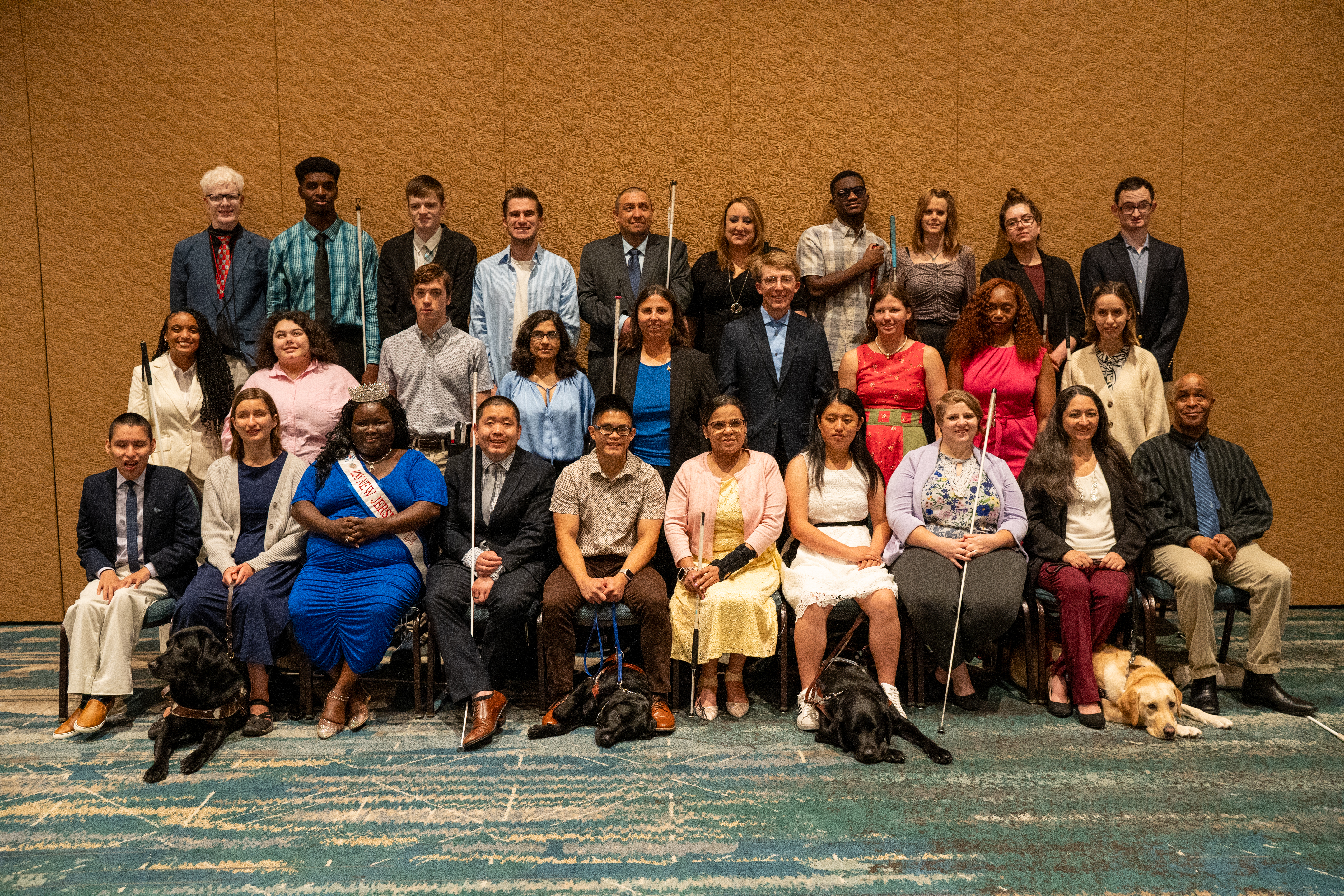A large group of scholarship winners wearing business formal at the national convention.