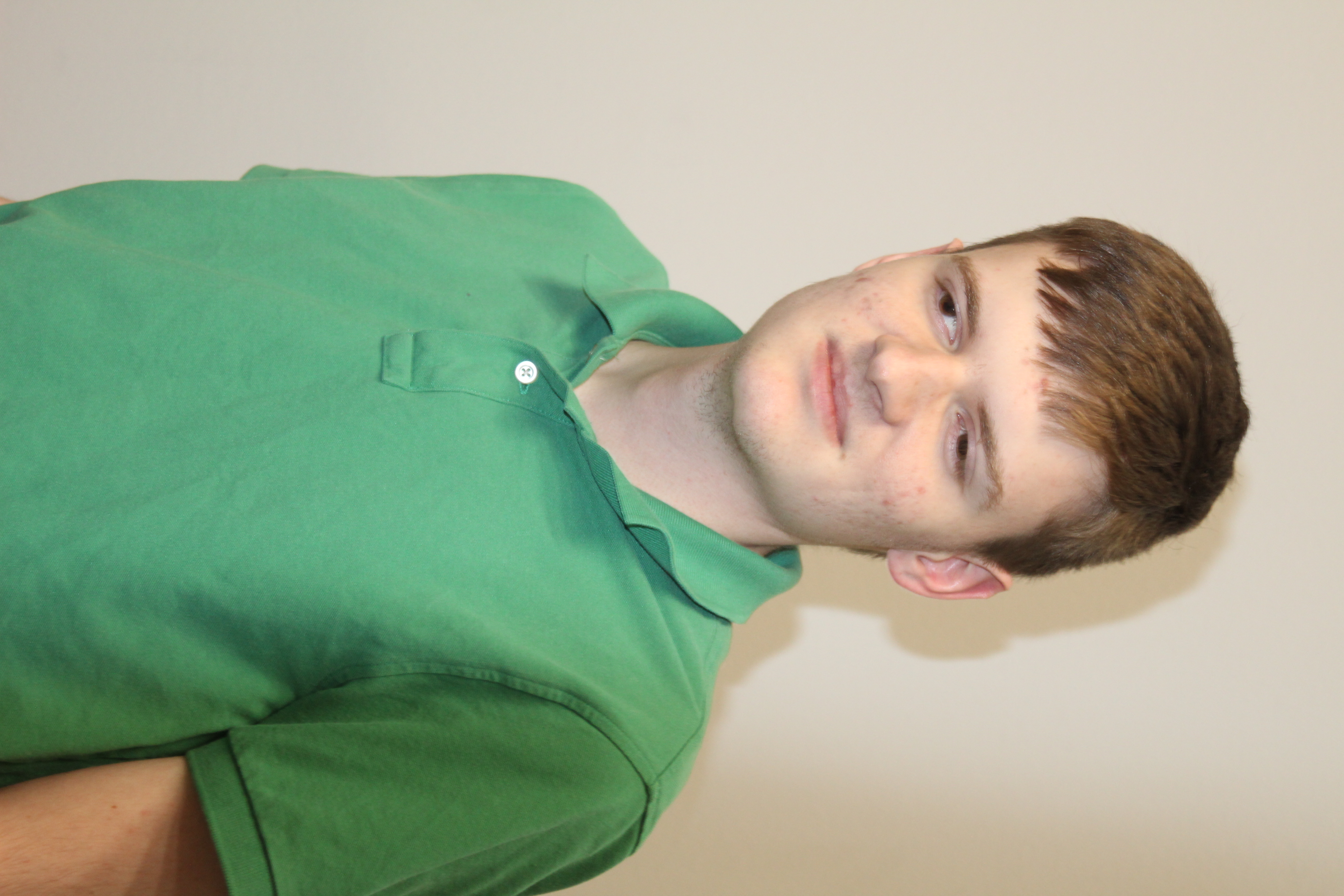 Benjamin Grelk wearing a green collared shirt.