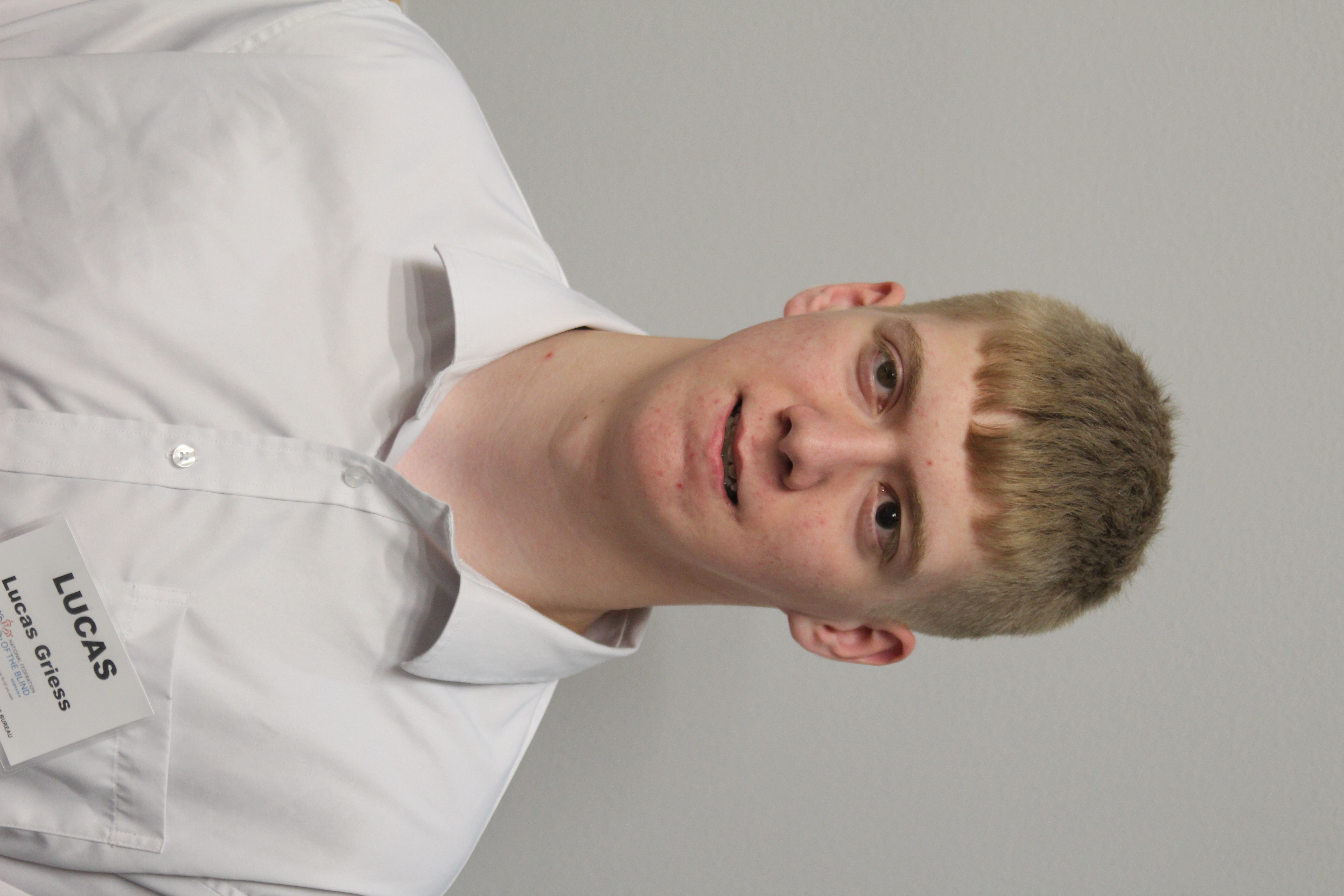 Lucas Griess wearing a white button-down shirt.